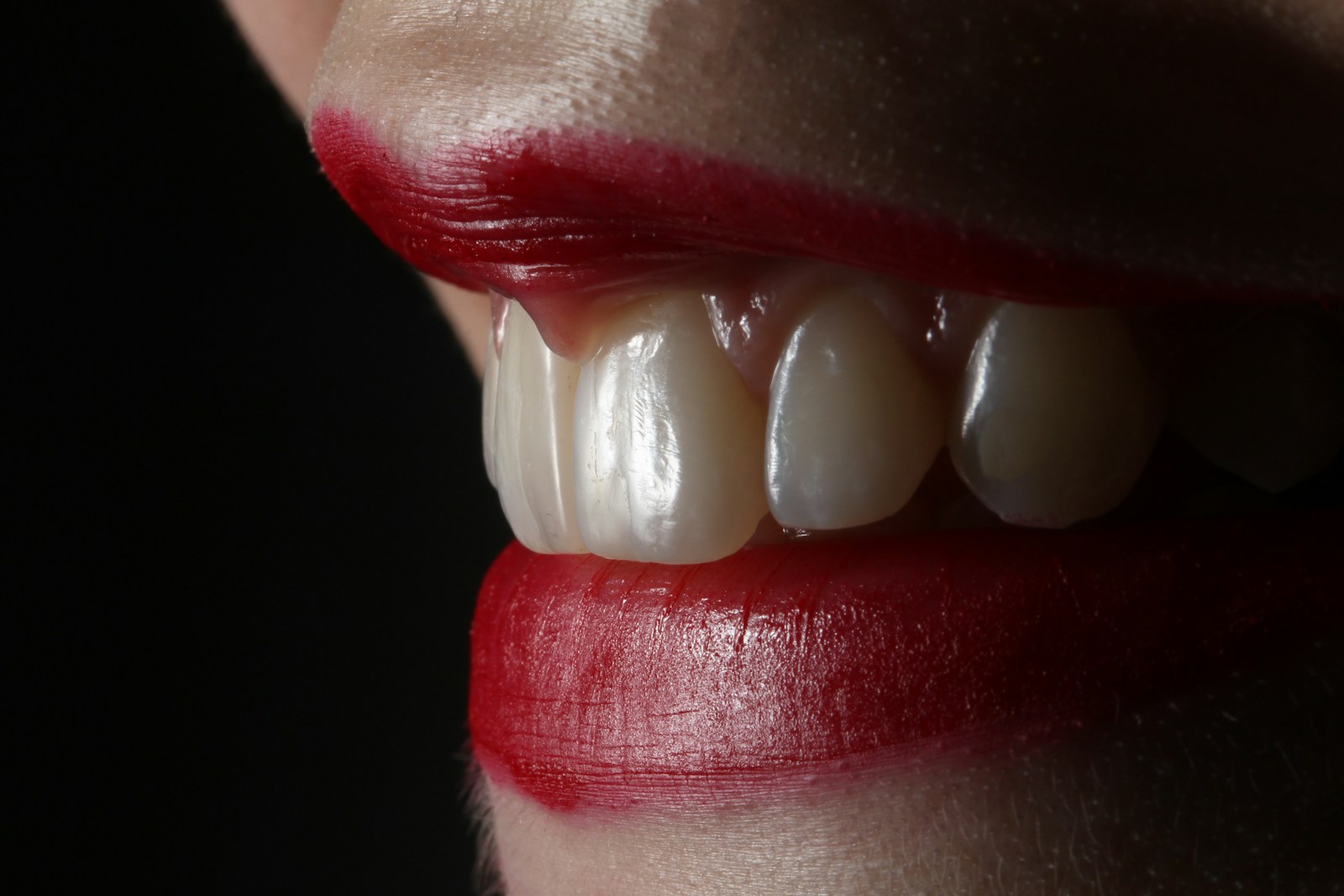 person with red lipstick and white pearl earrings